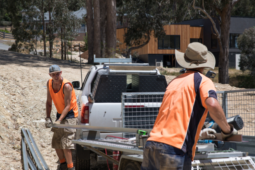 Young apprentice on a job site learning from a tradie mentor