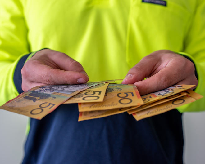 Tradie counting the upfront deposit he collected for a job