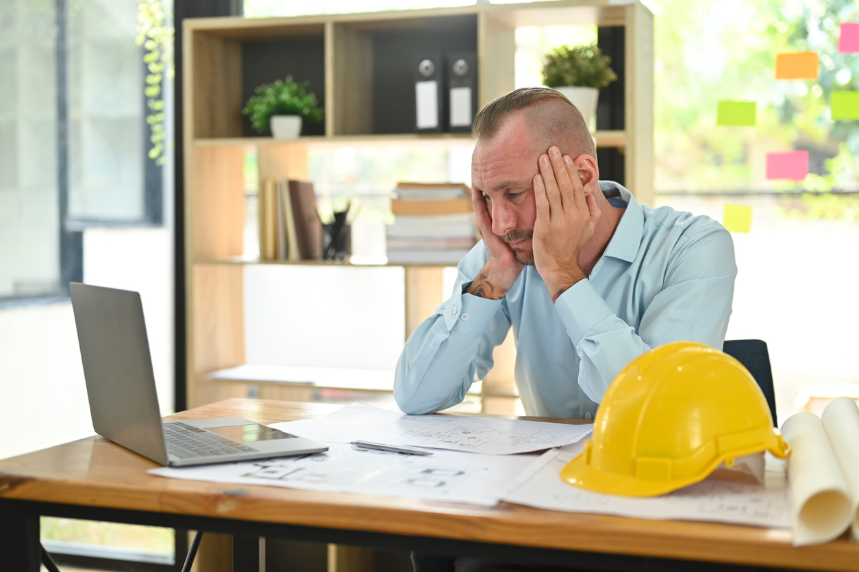 A tradie looking at bills during a slow period in the lead-up to EOFY