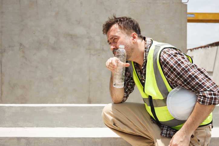 Brisbane builder thinking about checking invoices and project plans on site.