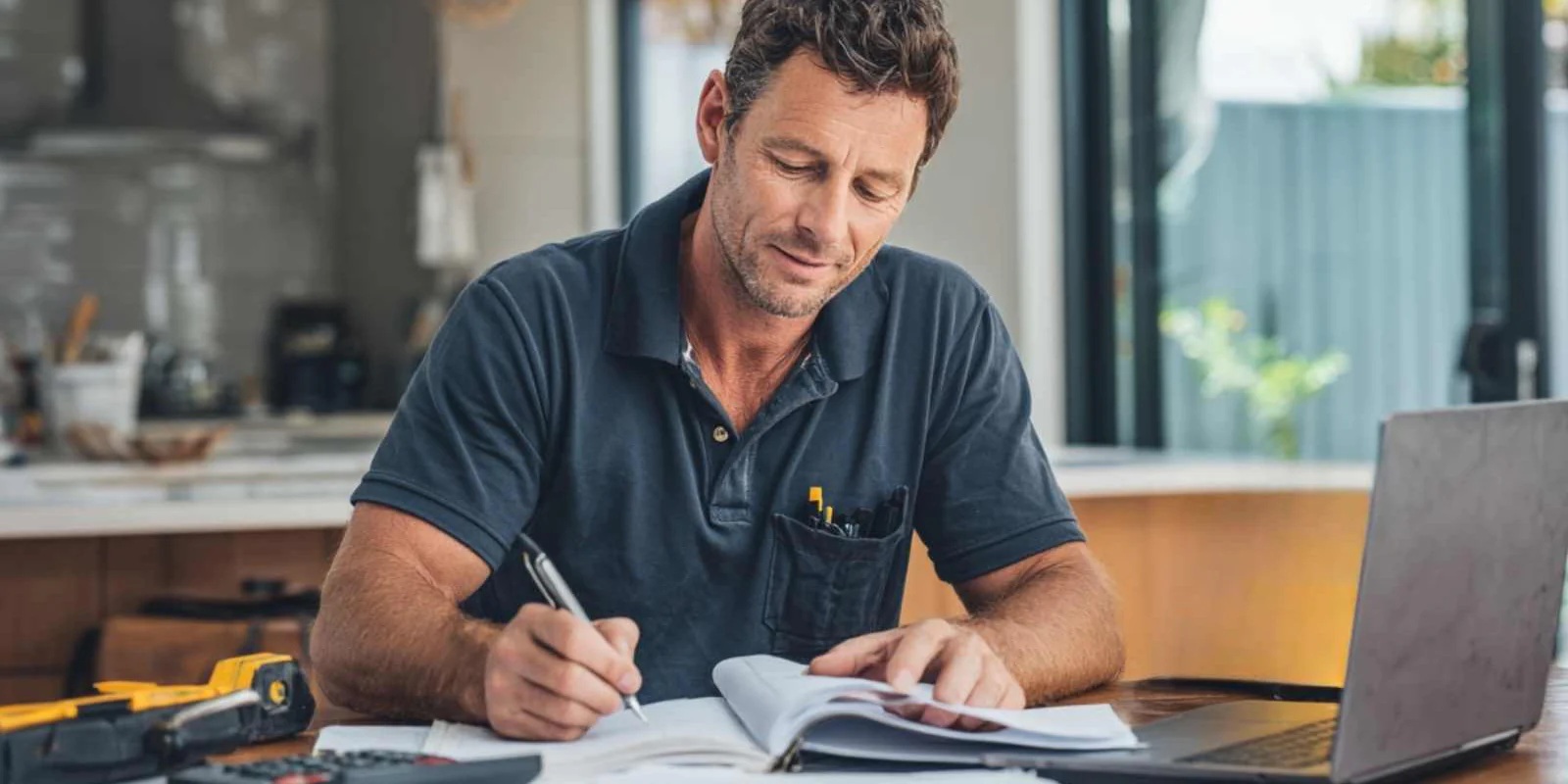 Accountant reviewing a clean reconciled Xero file for a tradie client on a laptop