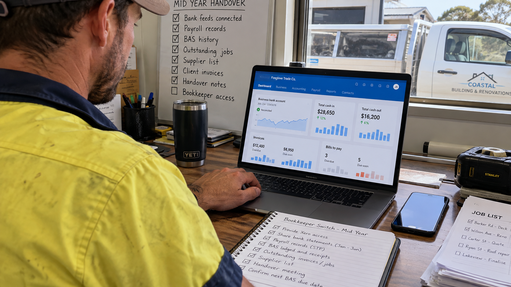 Australian tradie switching bookkeepers mid-year and checking business accounts on a laptop.